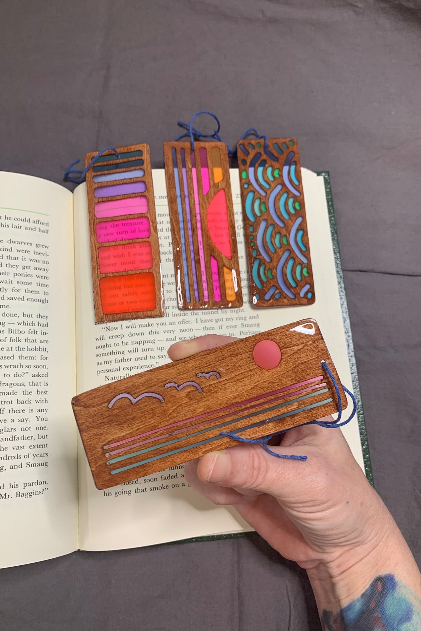 Hand cut wooden bookmark cut into a ocean sunset with birds using UV resin translucent colors